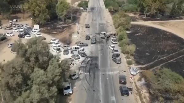 This image from video provided by South First Respo<em></em>nders shows charred and damaged cars along a desert road after an attack by Hamas militants at the Tribe of Nova Trance music festival
